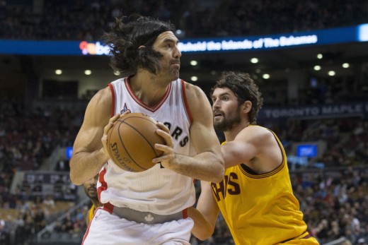 Toronto Raptors' Luis Scola, left, turns to shoot on Cleveland Cavaliers' Kevin Love during first half NBA pre-season basketball action in Toronto on Sunday, October 18, 2015. THE CANADIAN PRESS/Chris Young